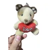 The beige bear pendant is decorated with red heart-shaped "love" embroidered characters Item Picture